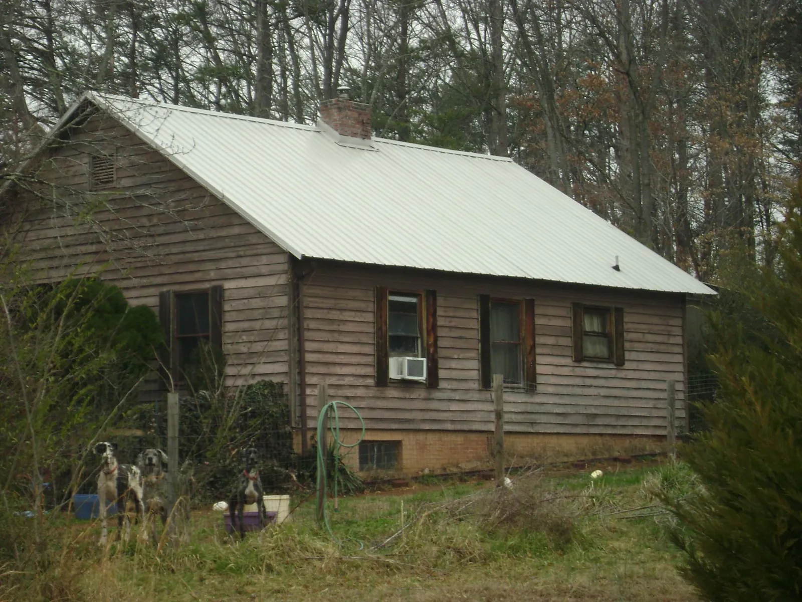 White metal roof on an old wood sided farmhouse, from a Metal Roof Installation job in Levittown